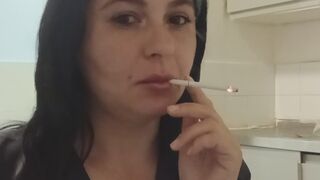 Brunette in black enjoying a cigarette