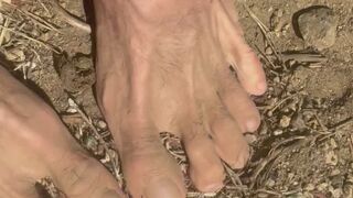 Big male feet getting dirty