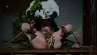 Novice Magda is tied to a wooden bench and treated with nasty stinging nettles