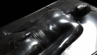 Black latex vacbed bondage