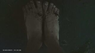 Bare Dirty feet walking by a river