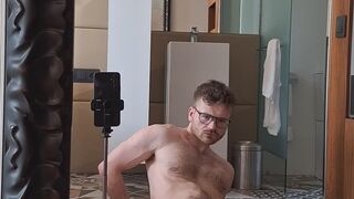 FTM in Speedos squirting in mirror