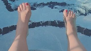 Splashing feet in pool with pink nail polish -JunieRose
