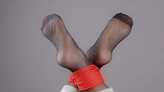 Tied Feet In Black Stockings