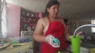 Wearing an apron and washing dishes