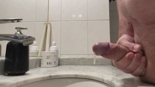 Slow-motion side view of a handjob ending in ejaculation.