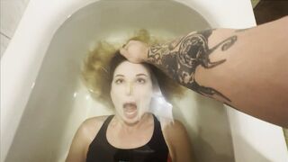 A frightened Milana practicing breath holding in her bathtub