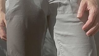 Jules wets his grey pants and exposes his semi-hard cock through his trousers