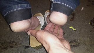 Bus stop wooden sandals bare soles tickling at public