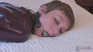 Ember hogtied in a Latex Body with a very special gag...