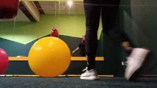 girl in gym play on gymballs