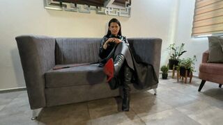 Kalinda smokes while dressed in leather