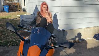Alice smokes a cigarette while posing on her motorcycle (1080)