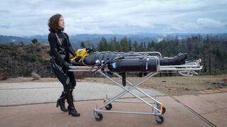 The Postapocalyptic Excursion - Delphine Mason and Elise Graves - Sealed in a neoprene bodybag, secured with straps from head to toe, and breathing only from a SCUBA tank, Delphine is taken on a sensory-less excursion outside the facility she is kept