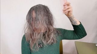 she is brushing her natural wet hair m0