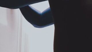 Shemale sucking a dildo wearing a shiny catsuit and a shiny leotard.