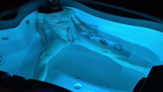 A boy takes a bath at night in a lit bathtub and gets excited
