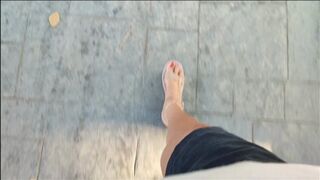 Mature woman driving driving and pumping pedals through the city (1)