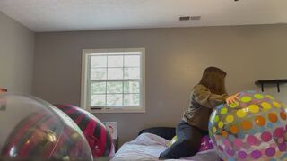 Popping a beach ball with scissors