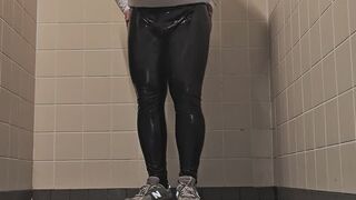 In bathroom with shiny leather leggings