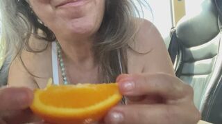 sucking oranges by the slice in her bra