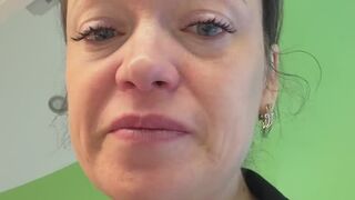 Crying and blowing her nose