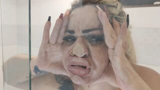 The blonde's big face squeezed into the glass.