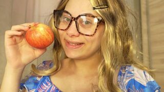 Blonde girl with glasses makes an ASMR video of herself eating