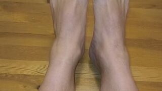 My bare legs rest on the tabletop.