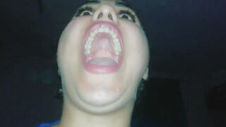 A realistic young woman yawning widely, clearly showing the roof of her mouth