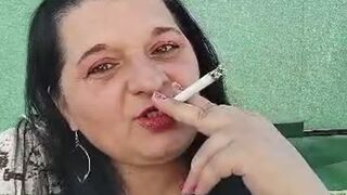 Smoking while applying lipstick