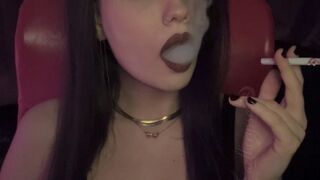 A slow, intimate cigarette in warm dim light