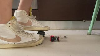 Old ruined Toy cars crushed under Nike blazer and fila disruptor sweaty sneakers