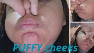 Fat girl puffing out her cheeks