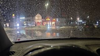 Sarah Struggling to Start Her Car in a Busy Parking Lot on a Rainy Night